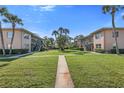 Beautifully maintained condo complex with central lawn, mature palms, and convenient exterior stair access at 216 36Th N Ave # 202B, St Petersburg, FL 33704
