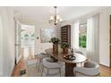 Elegant dining room featuring a chandelier, wine rack and access to other areas of the home at 2227 Brevard Ne Rd, St Petersburg, FL 33704