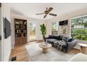Comfortable living room showcasing a ceiling fan, hardwood flooring, stylish decor, and natural light at 2227 Brevard Ne Rd, St Petersburg, FL 33704