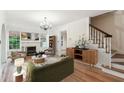 Bright living room with hardwood floors, fireplace, chandelier and neutral decor at 2227 Brevard Ne Rd, St Petersburg, FL 33704