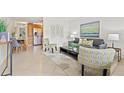 Inviting living room featuring tile flooring, modern decor, and an open layout to the dining area at 232 36Th N Ave # 202C, St Petersburg, FL 33704