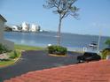 Scenic water view featuring lush landscaping, a tree, and boats near the building at 2700 Bayshore Blvd # 497, Dunedin, FL 34698