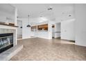 Open-concept living space with tile floors, fireplace, and views of the kitchen at 2749 Countryside Blvd # 20, Clearwater, FL 33761