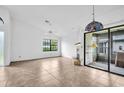 Spacious living room boasting tile flooring, bright windows, and sliding glass doors at 2749 Countryside Blvd # 20, Clearwater, FL 33761