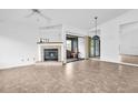 Bright living room with a fireplace, tile flooring, and sliding doors to a screened lanai at 2749 Countryside Blvd # 20, Clearwater, FL 33761