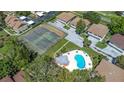 Aerial view of the Eastwood Shores community pool, tennis courts, and surrounding landscaping at 2935 Lichen Ln # D, Clearwater, FL 33760