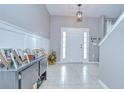 Welcoming foyer with tiled flooring, decorative lighting, and paneled walls at 3012 Magnolia Meadows Dr, Plant City, FL 33567