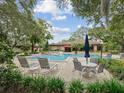 Community pool and lounge area with stylish furniture, perfect for relaxing and enjoying the outdoors at 3062 Eastland Blvd # 405, Clearwater, FL 33761