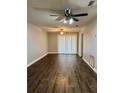 Bright living room with modern wood floors, ceiling fan, and natural light at 3802 N Oak Dr # W22, Tampa, FL 33611