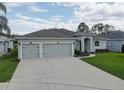 Welcoming single-Gathering home featuring a well-kept lawn and a convenient two-car garage at 3813 Salida Delsol Dr, Ruskin, FL 33573