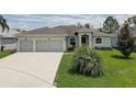 Attractive single-story home with lush green lawn and convenient two-car garage at 3813 Salida Delsol Dr, Ruskin, FL 33573