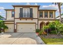 Beautiful two-story home with a three car garage, balcony and meticulously maintained landscaping at 4089 Windcrest Dr, Wesley Chapel, FL 33544