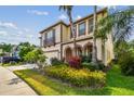 Charming two-story home with a three car garage and vibrant, well-manicured front yard landscaping at 4089 Windcrest Dr, Wesley Chapel, FL 33544