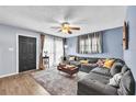 Cozy living room features a large sectional sofa, wood floors and stylish decor at 4425 W Bay Ave, Tampa, FL 33616