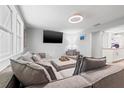 Comfortable living room featuring a large sectional couch, TV, and contemporary decor at 4570 67Th N St, St Petersburg, FL 33709