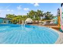Inviting backyard pool area with lounge chairs, a deck, and privacy landscaping, ideal for relaxation at 4570 67Th N St, St Petersburg, FL 33709