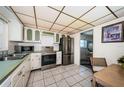 Classic kitchen with white cabinetry, stainless steel appliances, and a view of the dining area at 4750 Cove Cir # 1001, St Petersburg, FL 33708