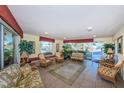 Inviting lobby with comfortable wicker furniture, plants and large windows offering views of the outside at 4750 Cove Cir # 1001, St Petersburg, FL 33708
