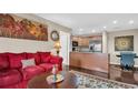Comfortable living room with a view of the adjacent kitchen and a vibrant painting at 4812 Jasper Dr # 203, New Port Richey, FL 34652