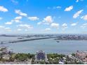 Elevated view showcases the building with bay views, boats and bridges on a sunny day at 500 N Osceola Ave # 811, Clearwater, FL 33755