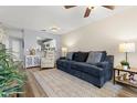 Comfortable living room featuring a modern sofa, fan, and updated flooring throughout the space at 5100 Burchette Rd # 2702, Tampa, FL 33647