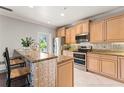 Bright kitchen features granite countertops, stainless steel appliances, and tile backsplash at 512 1St St # 108, Indian Rocks Beach, FL 33785