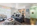 Cozy living room with dark wood floors, comfortable seating, and access to the kitchen at 512 1St St # 108, Indian Rocks Beach, FL 33785
