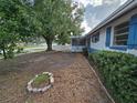Exterior showing the home's layout with a large tree and the front yard leading up to the property at 5175 88Th N Ave, Pinellas Park, FL 33782
