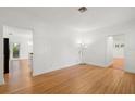 Bright living room featuring hardwood floors, neutral walls, and access to the kitchen at 526 36Th Ne Ave, St Petersburg, FL 33704