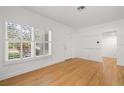 Sunlit living area showcasing hardwood floors, white walls, and a large window at 526 36Th Ne Ave, St Petersburg, FL 33704