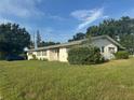 Charming single-story home with a lush green lawn, mature trees, and a classic front porch at 5600 9Th N Ave, St Petersburg, FL 33710