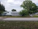 View of the home showing the white lattice skirting and the side of the property at 6095 108Th N Ave, Pinellas Park, FL 33782