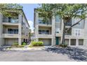 Three-story condo building features balconies, attached garages, green space and mature trees at 731 Cruise View Dr, Tampa, FL 33602