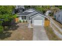 Inviting single-story home featuring a well-kept lawn, garage, and new wood fencing at 7551 52Nd N St, Pinellas Park, FL 33781