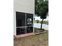 Enclosed patio with a lovely view of the lake and access to outdoor pier at 7616 Colonial Ct, Tampa, FL 33615