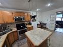 A functional kitchen featuring stainless steel appliances, an island, and ample cabinet space at 7920 52Nd N St, Pinellas Park, FL 33781
