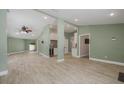 Spacious living room with modern flooring, open floor plan, neutral paint, recessed lights and ceiling fan at 941 65Th S St, St Petersburg, FL 33707