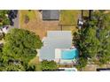 Aerial view of home showcasing backyard pool, patio, and mature landscaping with mature trees at 11110 105Th Ave, Largo, FL 33778