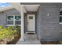 Close up of the house entrance with a white front door, column, and well maintained landscaping at 11110 105Th Ave, Largo, FL 33778