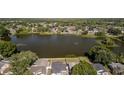 Aerial shot of a home by a lake, with lush landscaping and neighborhood views at 12416 Queensland Ln, Tampa, FL 33625
