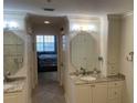 Elegant bathroom featuring dual sinks, granite countertops, and ample cabinet storage at 13313 Gasparilla Rd # 401, Placida, FL 33946