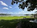 Serene waterfront view with bench seating, lush greenery, and tranquil scenery at 13709 Juniper Blossom Dr, Tampa, FL 33618