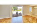 Bright room with wood floors and sliding doors that open up to a screened patio overlooking a pond at 13755 Orange Sunset Dr # 101, Tampa, FL 33618