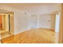 Spacious living room with wood-look floors, neutral walls, and sliding glass door with natural light at 13755 Orange Sunset Dr # 101, Tampa, FL 33618