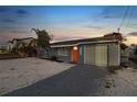 Charming single-story home with a vibrant orange front door and a well-maintained, light gray exterior at 13800 Judy Ave, Hudson, FL 34667