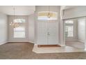 Bright foyer with double-door entry, chandelier, tile flooring, and neutral paint at 14266 Creek Run Dr, Riverview, FL 33579
