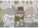 Aerial view showcases the property's boundaries, backyard, and waterfront access with boat docks at 15713 Century Dr, Hudson, FL 34667