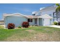Charming single-story home featuring a well-kept lawn, attached garage and mature landscaping at 15713 Century Dr, Hudson, FL 34667