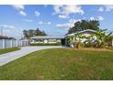 Charming single-story home with a well-maintained lawn, lush greenery, and a long driveway leading to the entrance at 1701 62Nd S Ter, St Petersburg, FL 33712