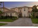 Charming two-story home with a paved driveway and well-manicured landscaping at 18050 Cozumel Isle Dr, Tampa, FL 33647